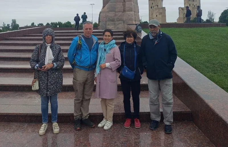 Our guide Makhfuza with guests at the Amir Timur statue in Shakhrisabz
